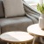 sunlight pours through a large window in furnished living room